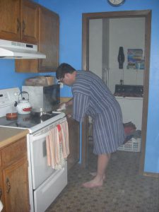 Dave cooking in his robe.
