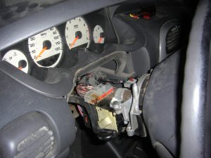 The steering wheel column with the plastic cover removed.