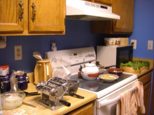 Messy counter with spinach drying in the background.