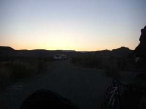 Sunrise on the third day. You can see the bikes leaned up in our "parking" spot with my sleeping bag sunning on a rack.