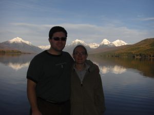 Jess and I in front of the snow covered mountains of Glacier National Park as seen from Apgar Villiage.