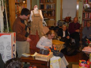 Jess opening presents with Nancy, Bob, and Shirlie looking on in rapt fasination.