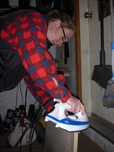 Jess applying some edge-banding to one of the shelves in our new custom desk.