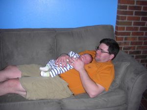 Daddy and Phoebe resting comfortably. Dad's tummy makes a stellar pillow!