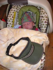 Mom's visor is about as big as the baby! Phoebe sleeps in the coffee shop.