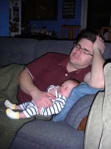 Daddy and baby take a pre-bedtime nap.