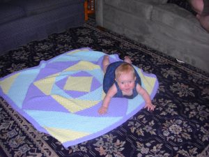 Playing on a blanket.