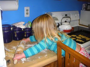 Rolling out sugar cookie dough.