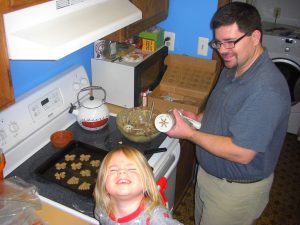Phoebe and Daddy work on Christmas spritzes.