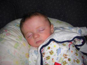 Comfy with his new farm blanket from Uncle Matt and Aunt Erin.