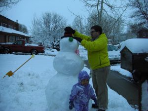 Daddy adds the finishing touches. (Thanks, Uncle Matt and Aunt Erin, for the snowman kit!)