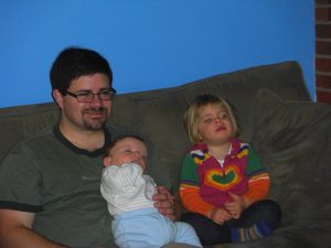 Everybody except Mommy watches TV on a snowy Sunday evening. (I was making dinner.)