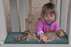 Phoebe working on a project on the playground.