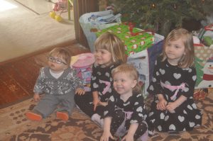 Three matching girl cousins and their little boy.