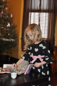 Genevieve opening some gifts.