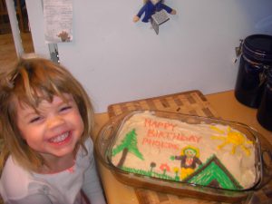 Adorable girl with birthday cake.