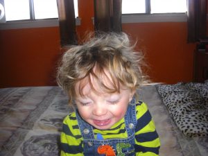 Smiling curly head without his glasses.