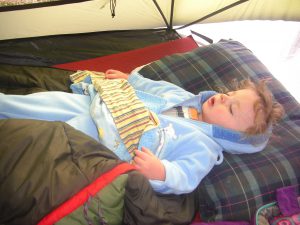 Still sound asleep in his fleece jammies, snowsuit, and blankie.