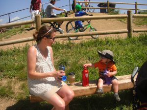 Aunt Erin and Benjamin share a bench at the Valmont Bike Park.