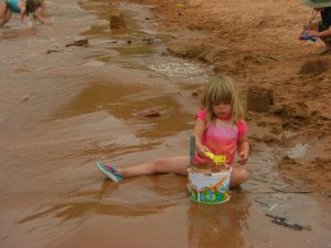 Phoebe filling up her camping bucket.