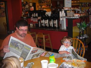 The gentlemen are reading together.