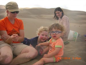 Jess, Tilley, Benjamin, and Maggie at the top of a dune.