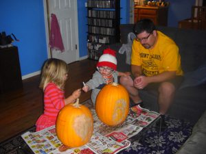 Benjamin was far more eager to draw on Phoebe's pumpkin than his own.