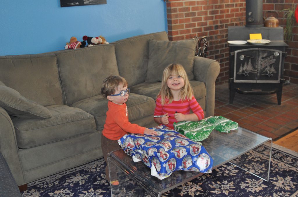 Tag-team present opening. Benjamin needed a wee bit of help with his birthda gifts in September, but that was not the case by Christmas!