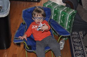 Benjamin in his new camping chair with a new truck.