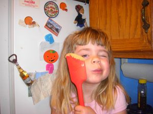 "Mom, take a picture of me winking with the spatula!"