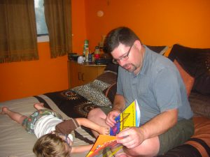 Daddy reading Benjamin a bedtime book.