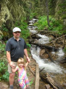 Phoebe and Daddy posing by a waterfall.