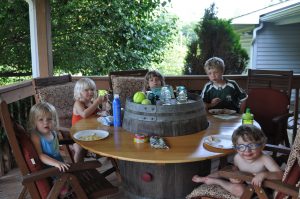 The kids eat lunch at the table Uncle Matt made.