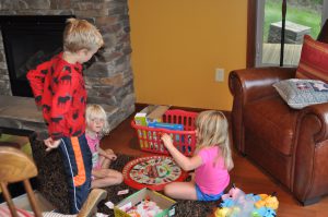 Kids amusing themselves with games in the basement.