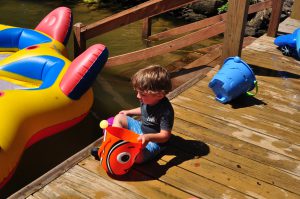 Benjamin playing with a water bucket.