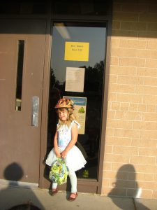 Phoebe standing at Mrs. Moore's door on the first day of kindergarten.