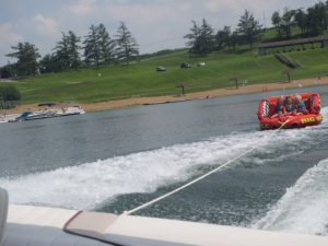 The boat pulling the tube.