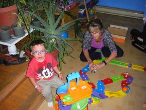 Grammie and Benjamin playing cars.