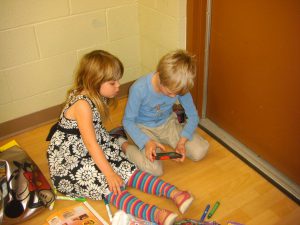 Phoebe and Alexander absorbed in their media.