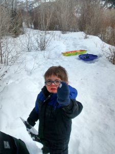 Benjamin shows off a snowball he made (the snow was very icy).