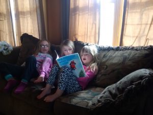 The girls reading together: Marin, Charlotte, and Phoebe.