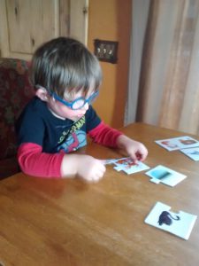 Benjamin doing a puzzle from Grammie.