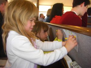 Phoebe and Julia creating Easter lilies.