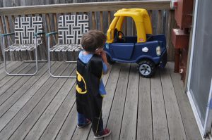 Batman contemplates a ride in the mobile.