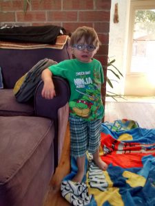 Cool Joe. Teenage Mutant Ninja Turtles tee-shirt, board shorts, and his Lego movie blanket.