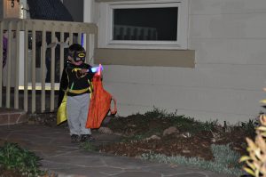 Benjamin trick or treating and playing with his "light savers."