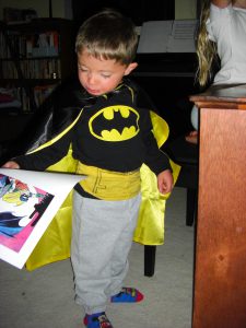 Holding his Batman picture.